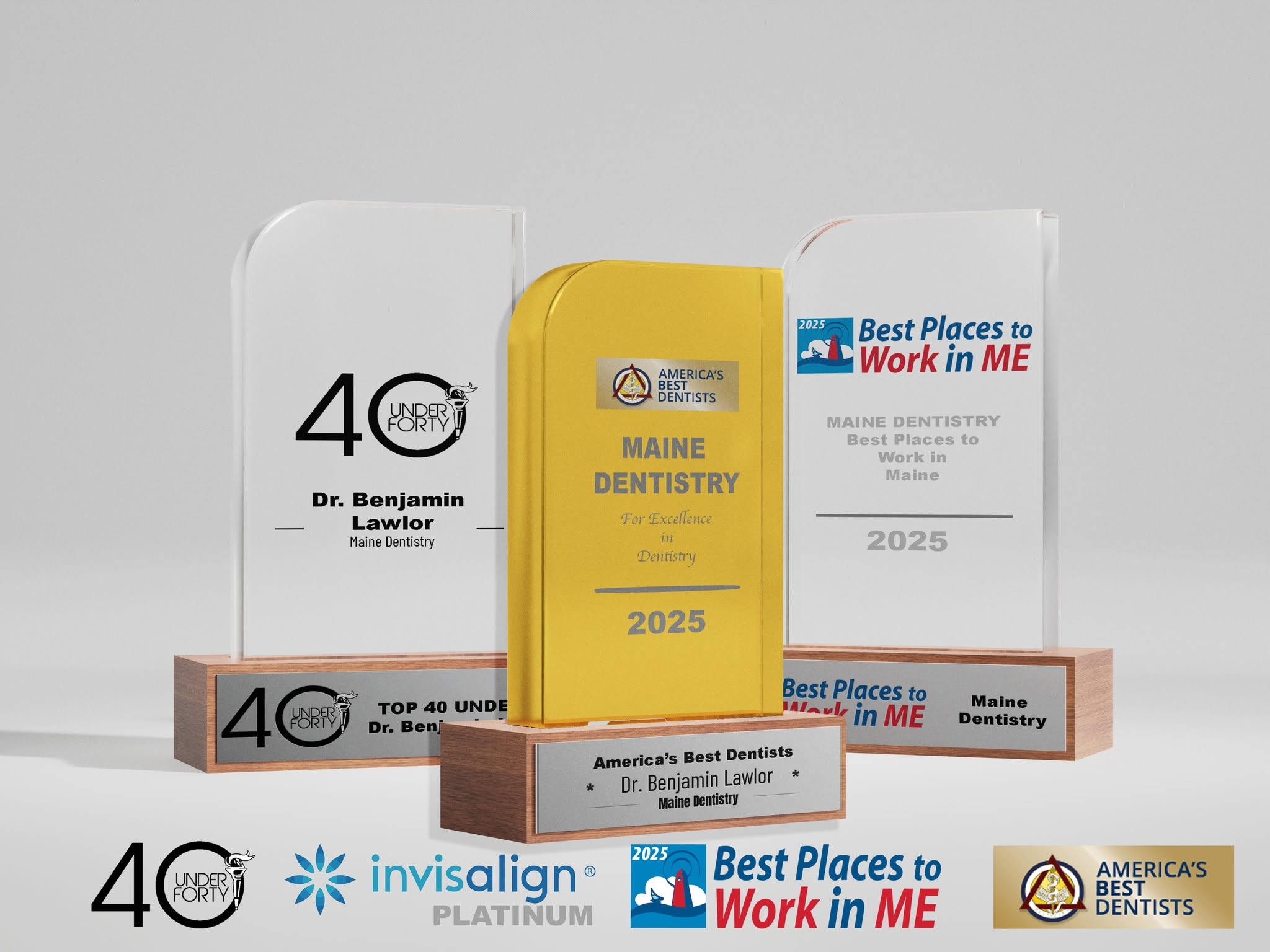 Practice-supplied awards photograph: Dr. Benjamin Lawlor’s 40 Under 40 honor and Maine Dentistry’s 2025 Best Places to Work in Maine recognition, alongside other historical award and provider artwork